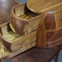 Each drawer bottom reveals a different zebrawood parquetry pattern.
